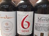 three bottles of wine sitting on top of a table next to each other