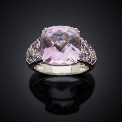 an amethorate and diamond ring on a black surface