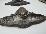two old metal objects that are on a table