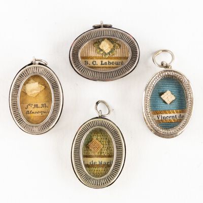 four antique silver and enamel lockes with different designs on them