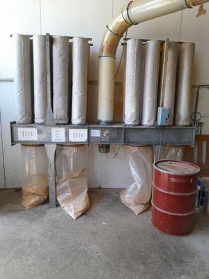 many rolls of paper sitting on a shelf next to a red barrel