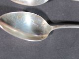 two spoons that are sitting on a table