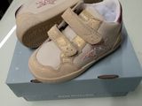 a box with a pair of baby shoes on top of it