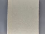 a book with a white cover sitting on top of a table