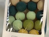 a box of assorted colored balls in it