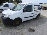 a small white van parked in a parking lot