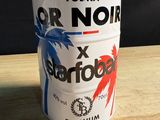 a can of vodka on a wooden table with a black background