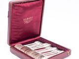 a red case with silverware in it on a white surface