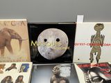 various vinyl albums and cds on display on a table