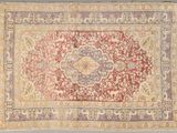 an antique persian rug with a medallion design on a grey background
