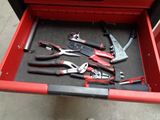 many tools in a tool box on the floor