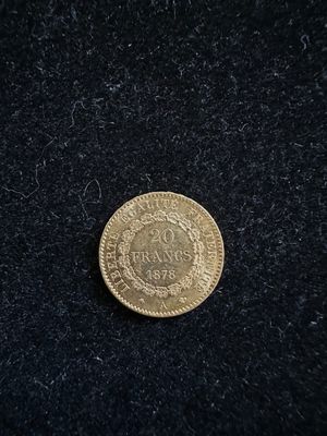 gros plan d'une pièce d'or sur une surface noire