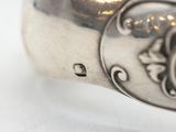 a close up of a silver ring on a white surface