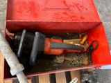 a red box with tools inside of it on a pallet