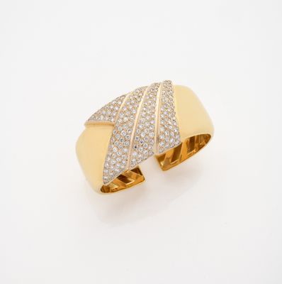 gros plan d'une bague en or et diamants sur une surface blanche