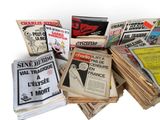 several newspapers are stacked on top of each other on a white surface
