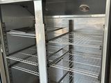 an empty refrigerator with a lot of shelves inside of it