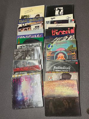 a lot of cds on the table next to a mouse