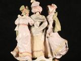 figurine of a group of people dressed in period clothing