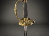 a gold and black sword with a handle on a black background