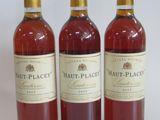 three bottles of wine sitting next to each other on a white surface