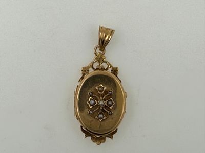 a close up of a gold locke on a white surface