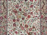 a rug with a tree of life and birds on it