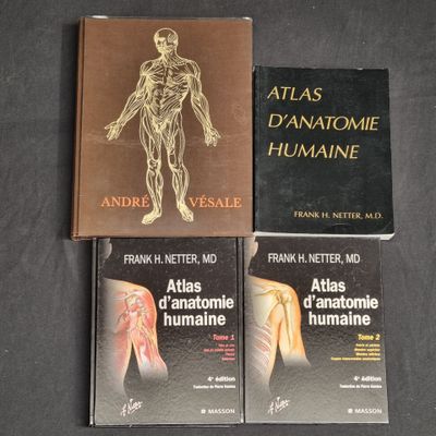 three books on a table with a black background and a brown cover