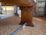 a close up of a wooden bench on a carpeted floor