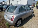 a silver car that is parked in a parking lot