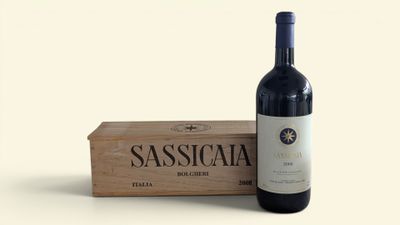 a bottle of wine sitting next to a wooden box