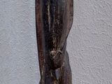 a small statue of a man standing on a wooden base