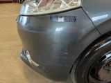 a close up of a car ' s headlight with a sticker on it