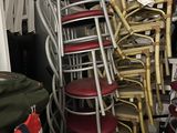 a lot of chairs that are stacked on top of each other