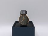 black and gold watch in a black box on a white background