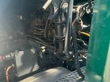 a close up view of the engine of a green truck