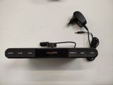 a remote control and a charger on a table