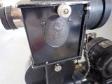 a small black camera with a metal case on it
