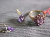 two rings and a pair of earrings laying on a table