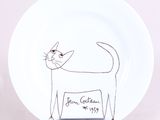 a white plate with a drawing of a cat on it