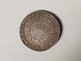 a close up of a coin on a table with a white background