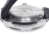 a close up of a watch on a white surface