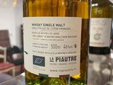 a bottle of whisky on display in a glass case