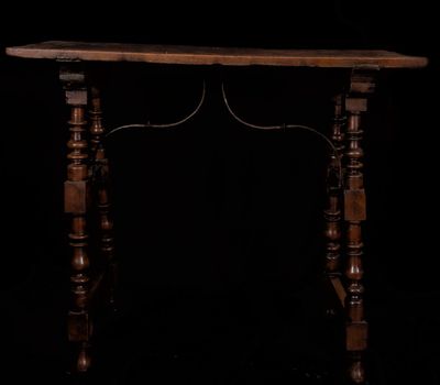 an old wooden table with turned legs and a wooden top