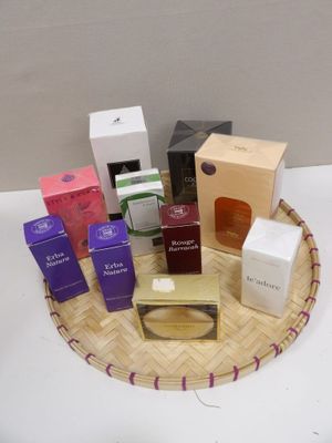 many different types of perfumes in a basket on a table