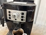 a coffee maker with a cup of coffee on the counter
