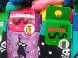 many pairs of socks that are sitting on a table
