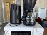 a coffee maker and a coffee pot on top of a microwave