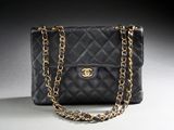 a black chanel bag with a gold chain strap
