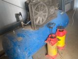 a blue tank with a fan next to a yellow can
